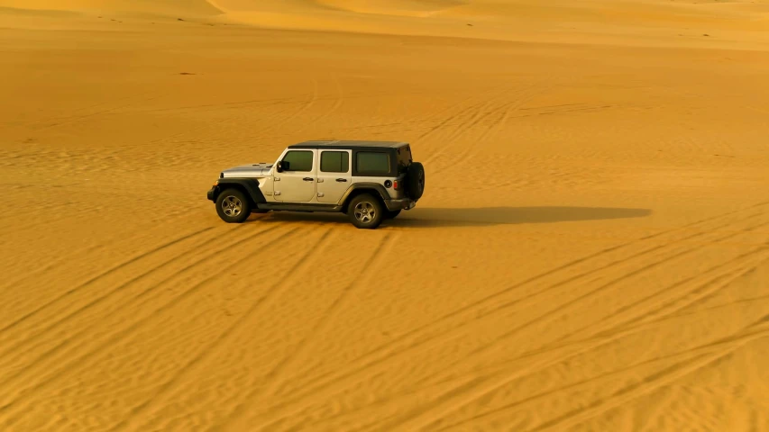 there is a white jeep in the desert