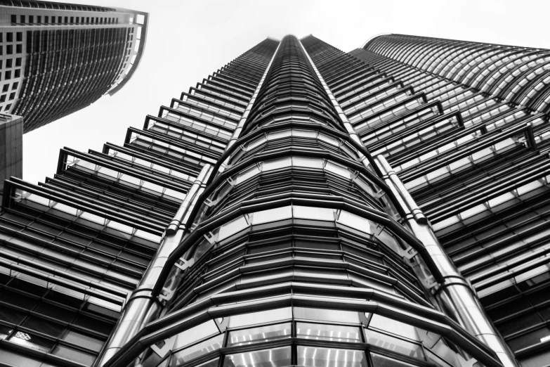 this image shows the top of a building with the face of a tall, slender skyscr