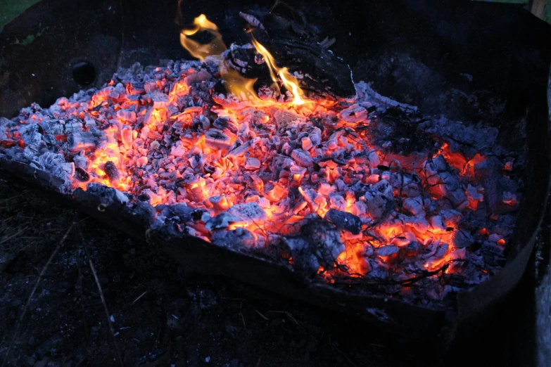 a big metal pot filled with soing glowing red