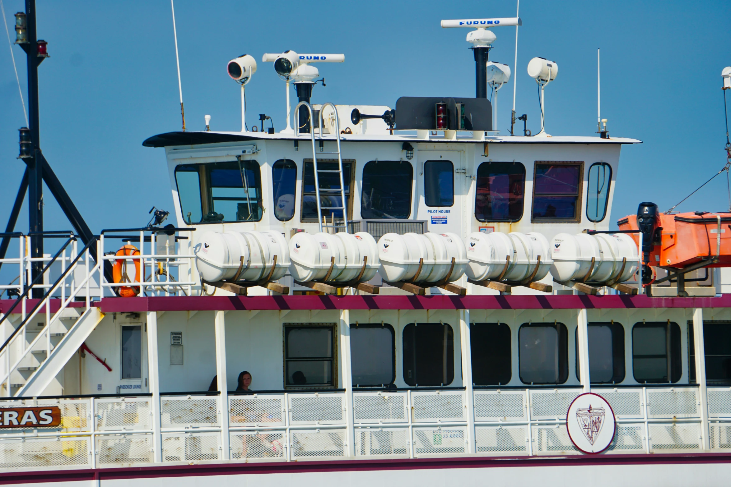 the large boat is sailing on the river with many hoses