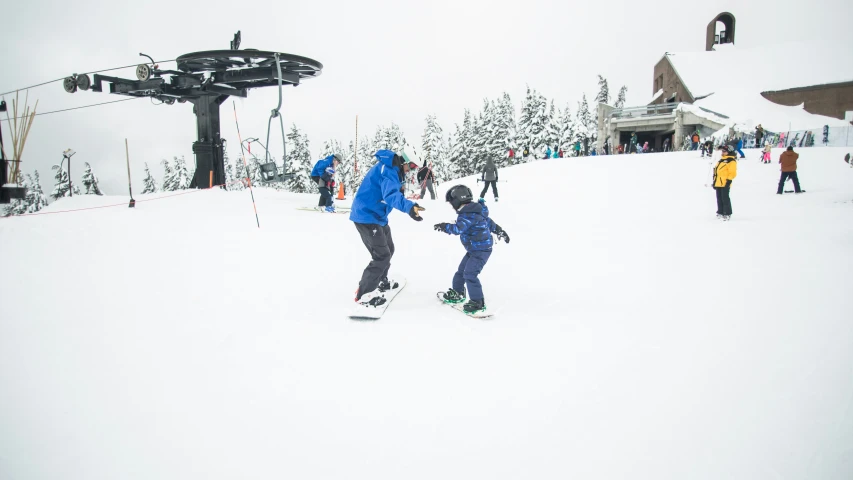 people at the bottom of a ski slope as they prepare to head down a slope