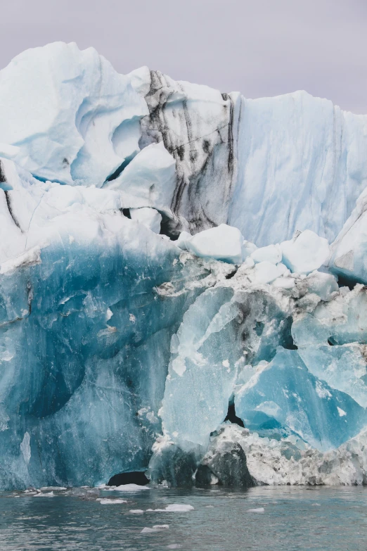 a view of the ice from the water in front of an icy iceberg