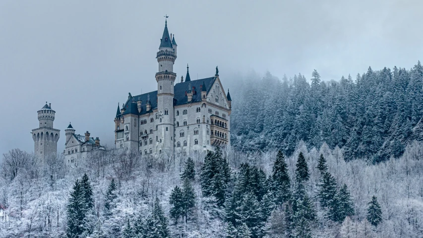 a large building on top of a snowy hill