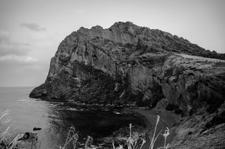 a hill side with sea in the foreground