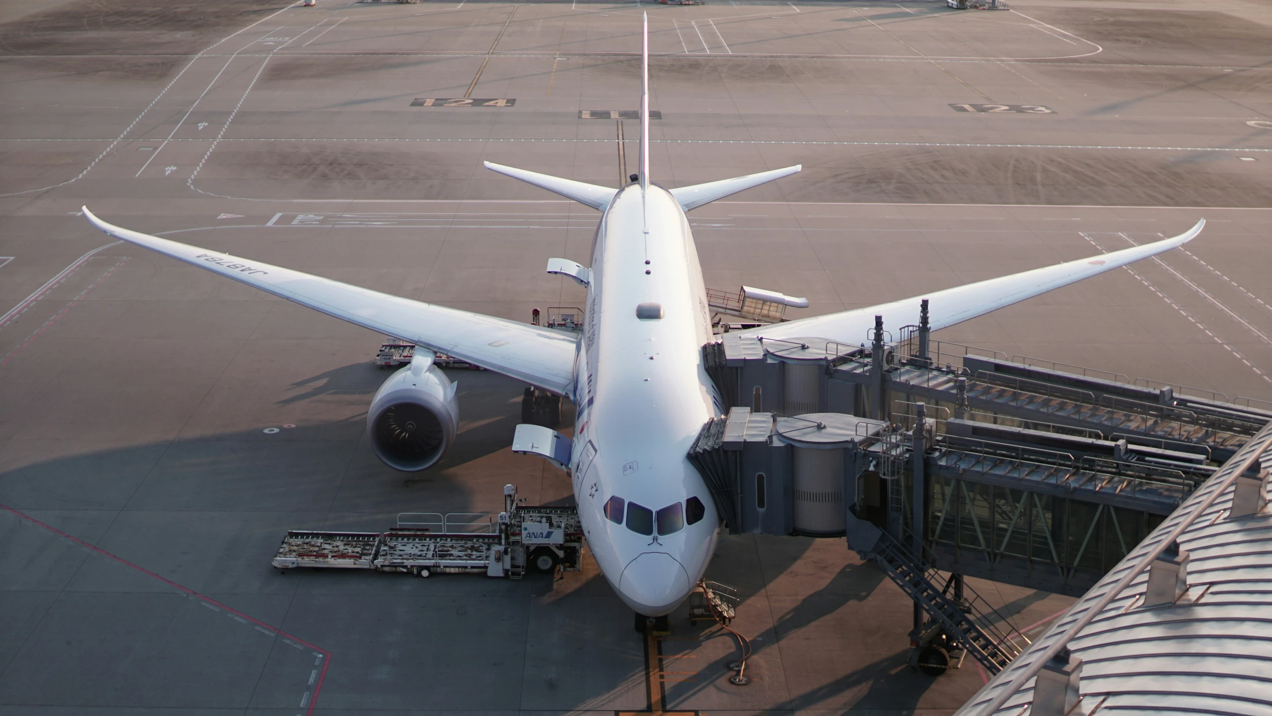 a plane that is being boarded by passengers on the tarmac