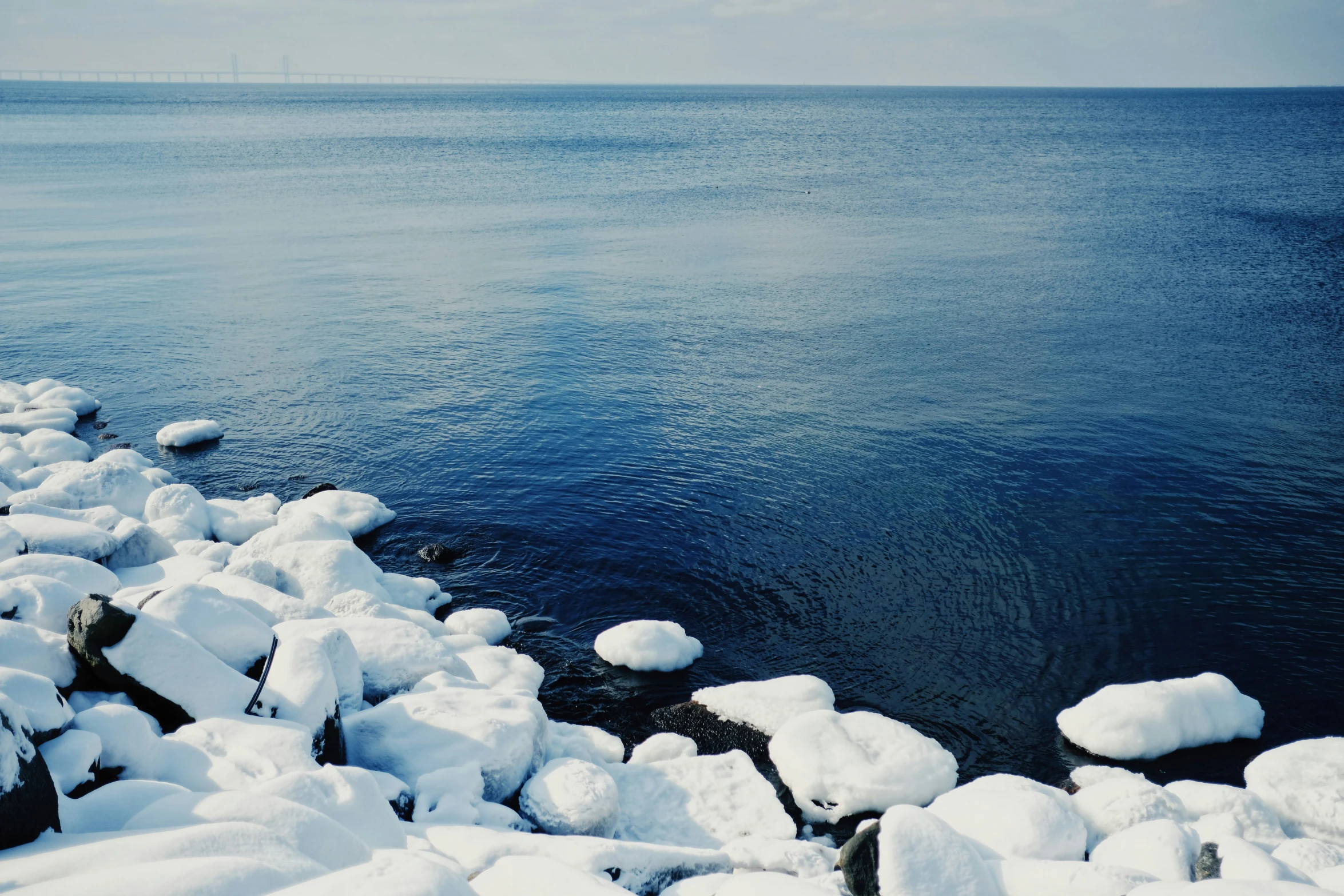 snow covers the ground and the water