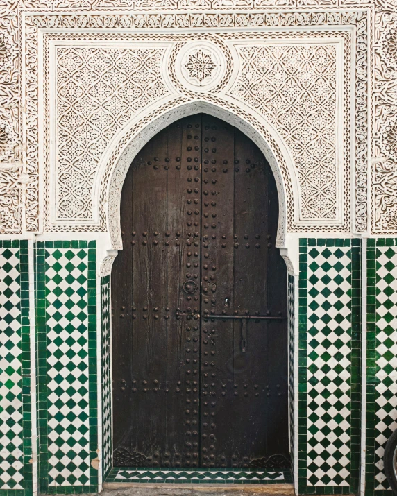 there is a large doorway with green and white designs