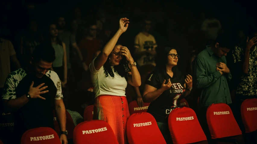 two women with glasses are sitting in the stadium