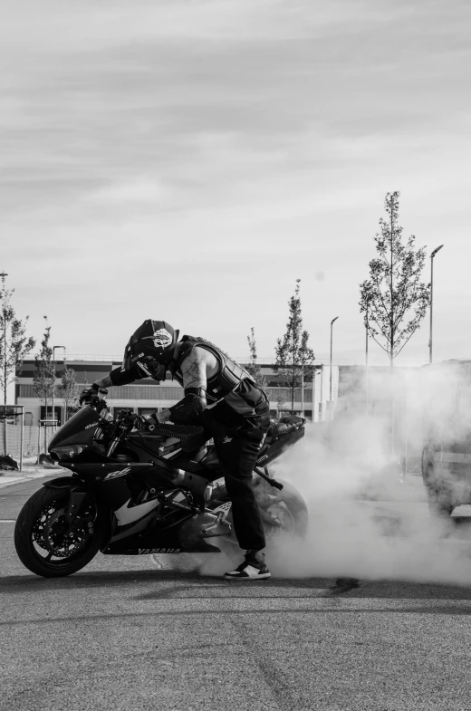 a black and white po of two people on a motorcycle