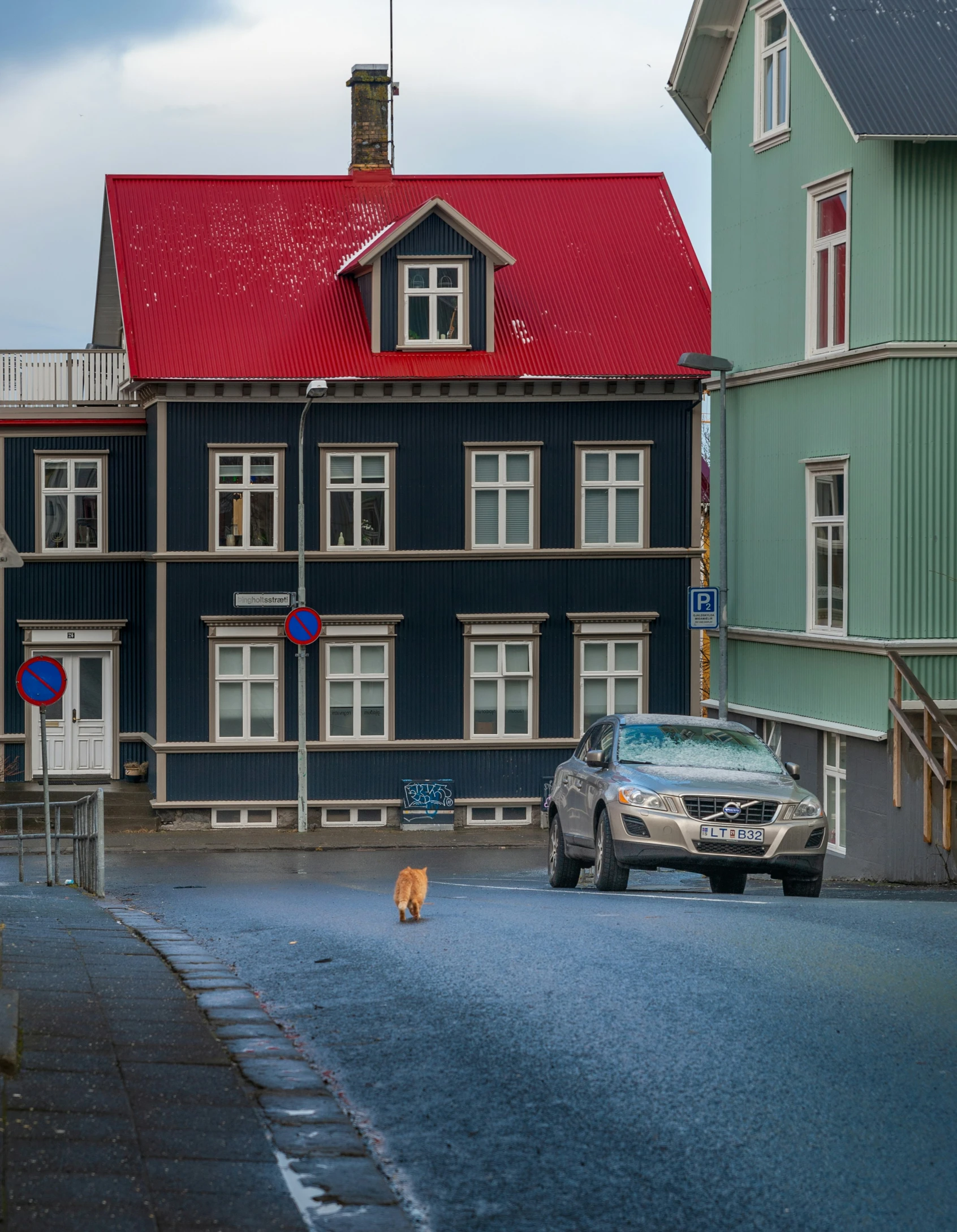 a blue house and a car in the street