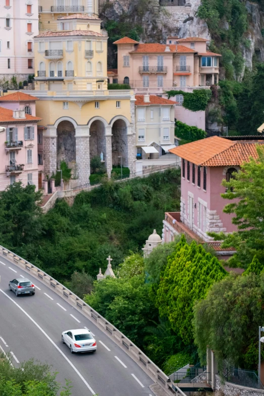 a view of some buildings and cars on the road