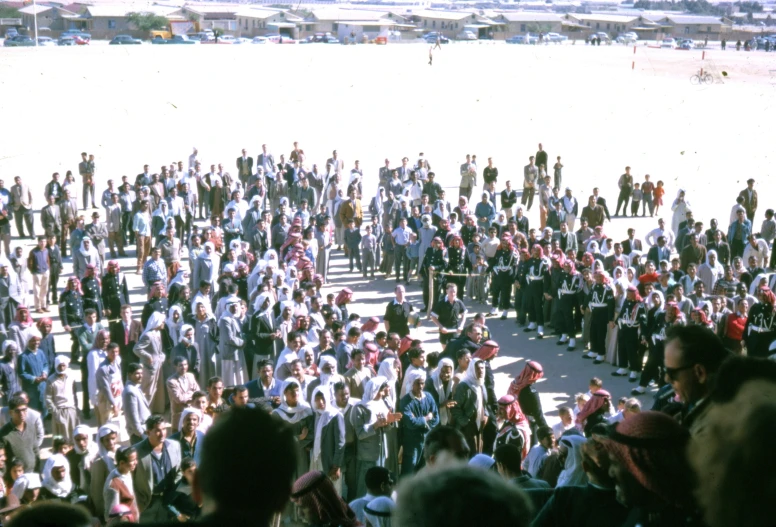 a crowd of people standing together in front of an audience