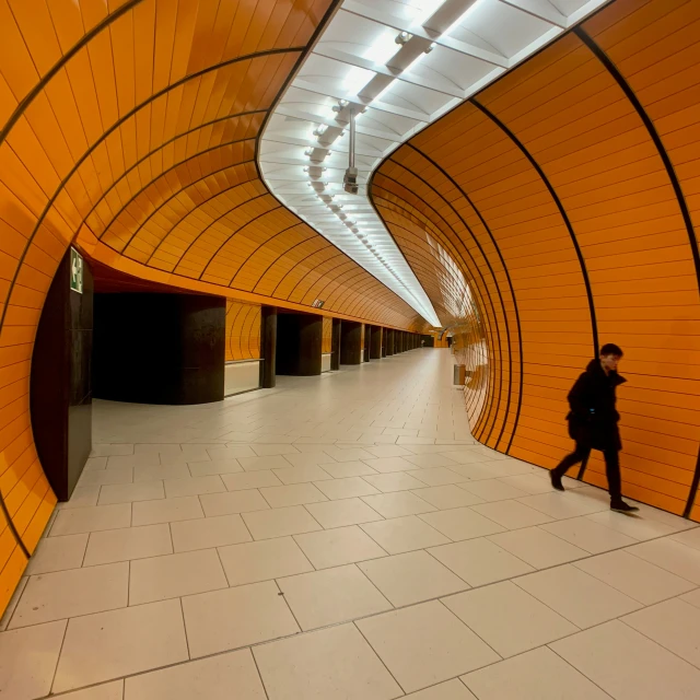 a couple walking down a corridor near a building