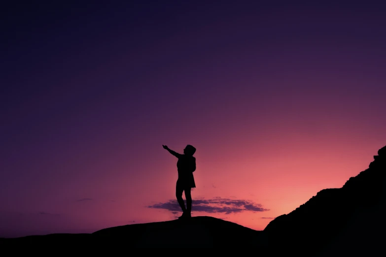 a person is standing on top of a hill