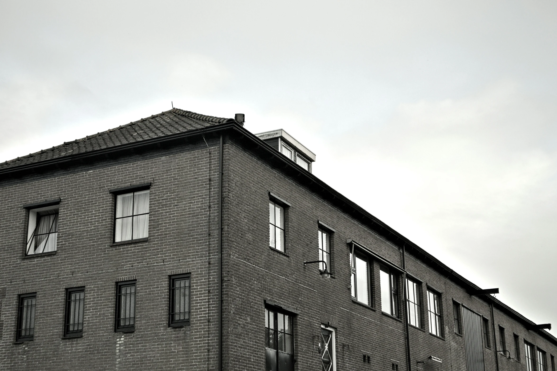 a building with lots of windows and small clouds