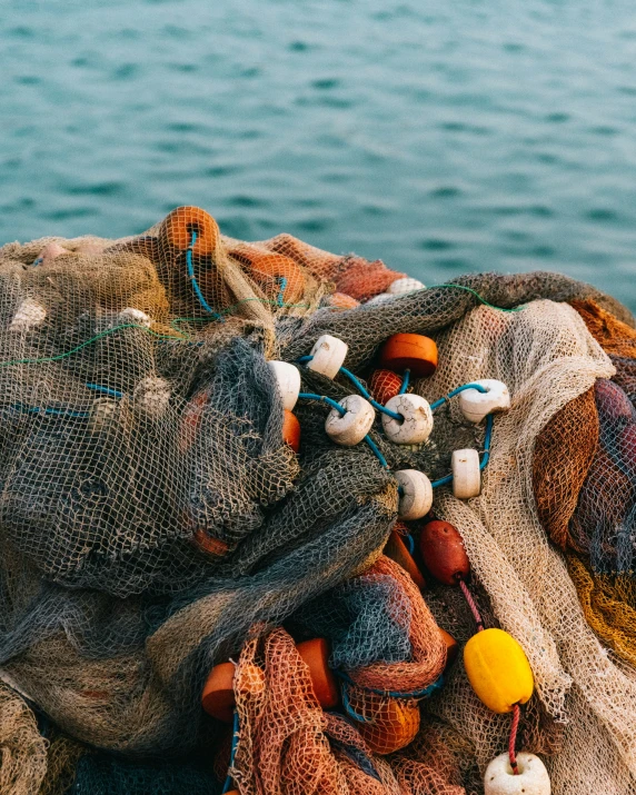 an assortment of fishing accessories sit on the sand