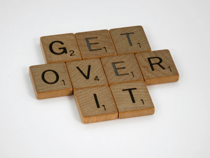 scrabble type wood letter tiles spelling'get over it '