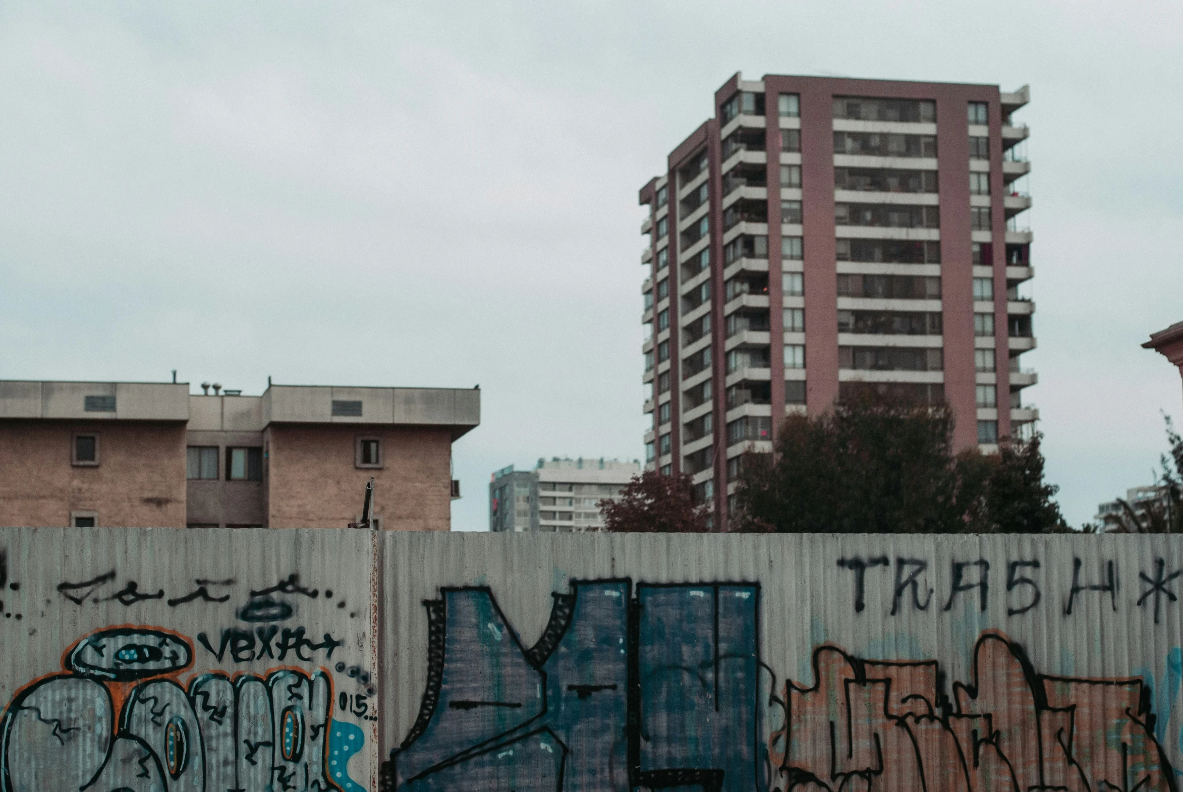 a tall building sitting next to a graffiti covered wall