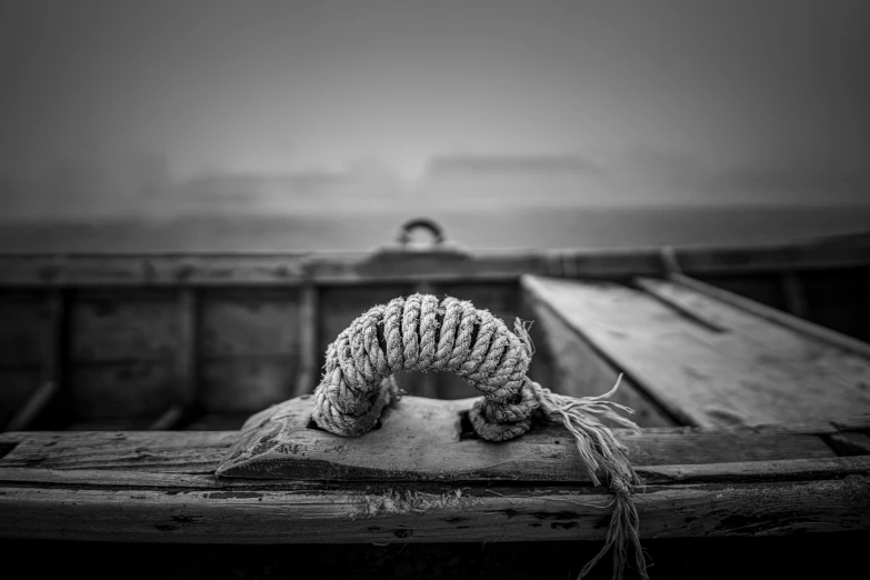 a rope wrapped in to a boat on a body of water