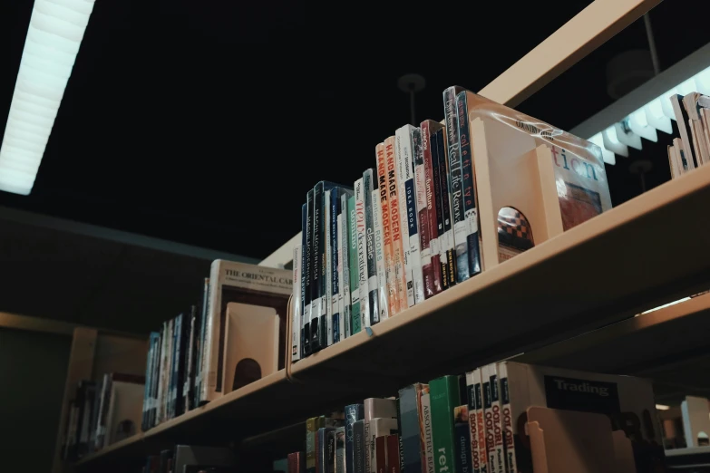 a bunch of books that are on a shelf