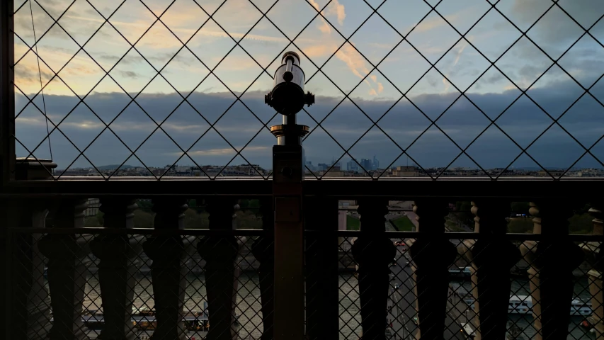 an iron fence is next to a dark fire hydrant