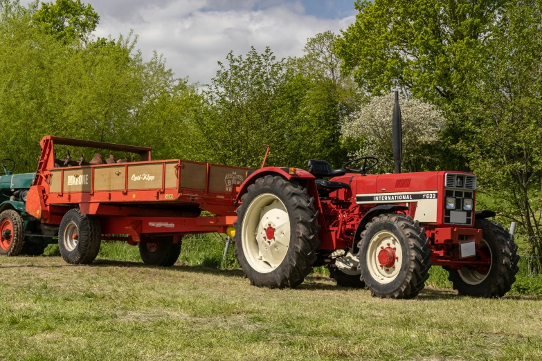 two large farm tractors in an open field