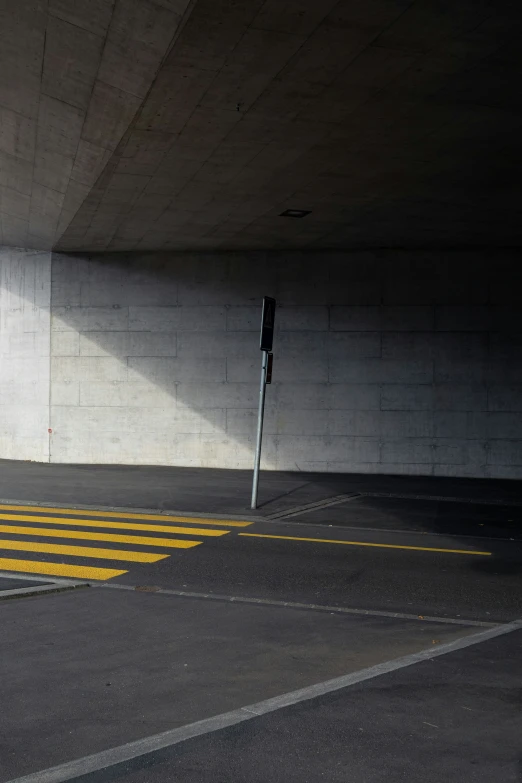 a parking space with some white walls and two parking meters