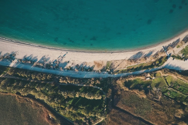 an aerial view of a sandy beach and a blue ocean