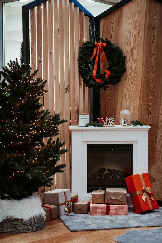 some presents wrapped in paper sit near a christmas tree