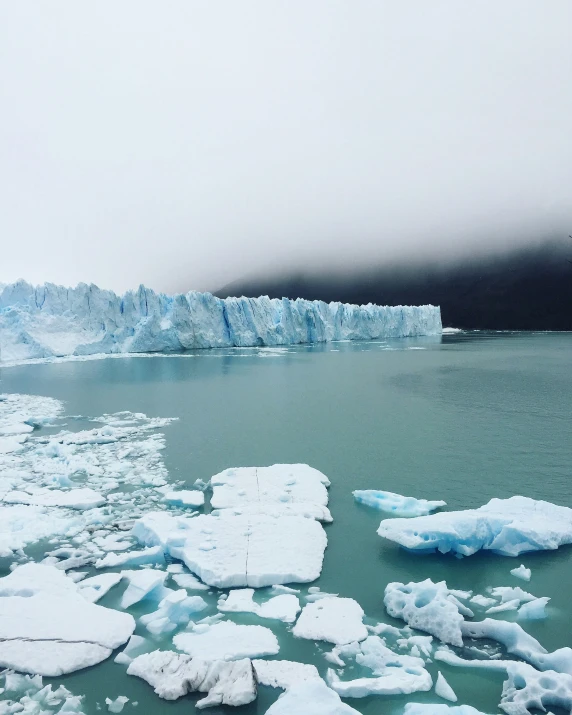 an iceberg looks like it's coming off of a huge glacier