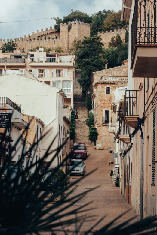 a street with buildings along it and a mountain in the background
