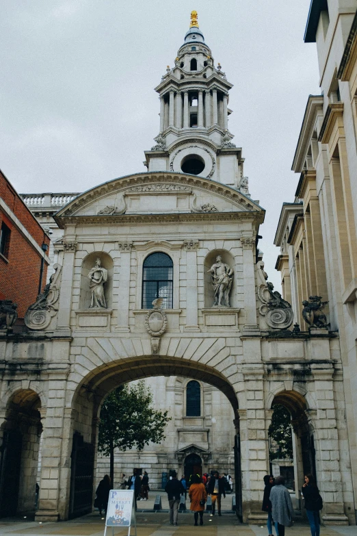 a church with an archway leads to another building