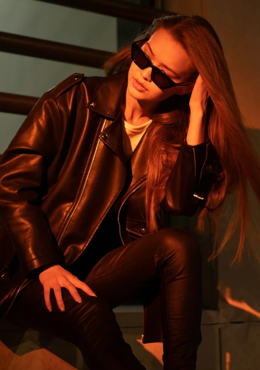 an attractive woman wearing dark colored clothes and shades