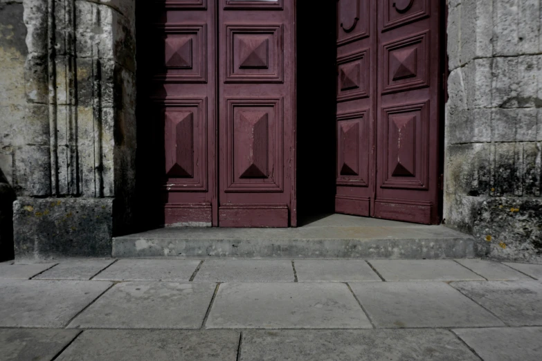 there are two wooden doors in an old building