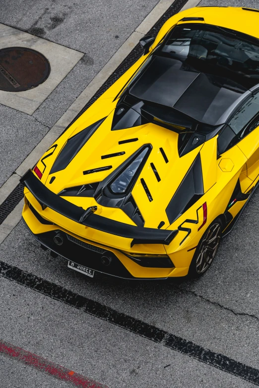 a yellow sports car parked on the street