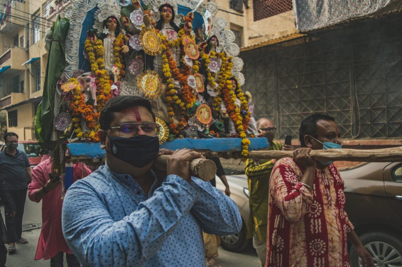 a man wearing a face mask in front of a shrine