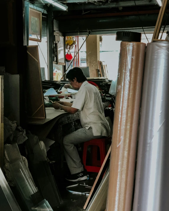 a man works on construction work in a workshop