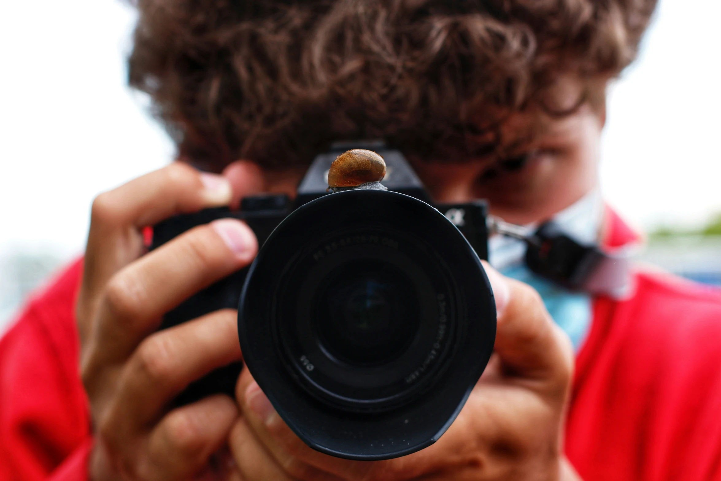 someone taking a picture of a boy with his camera