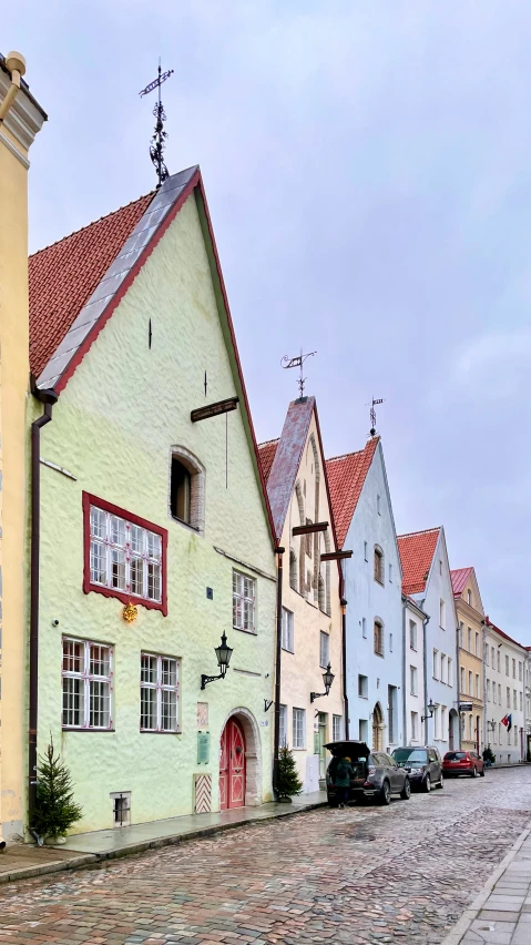 a cobblestone street with several colorful buildings