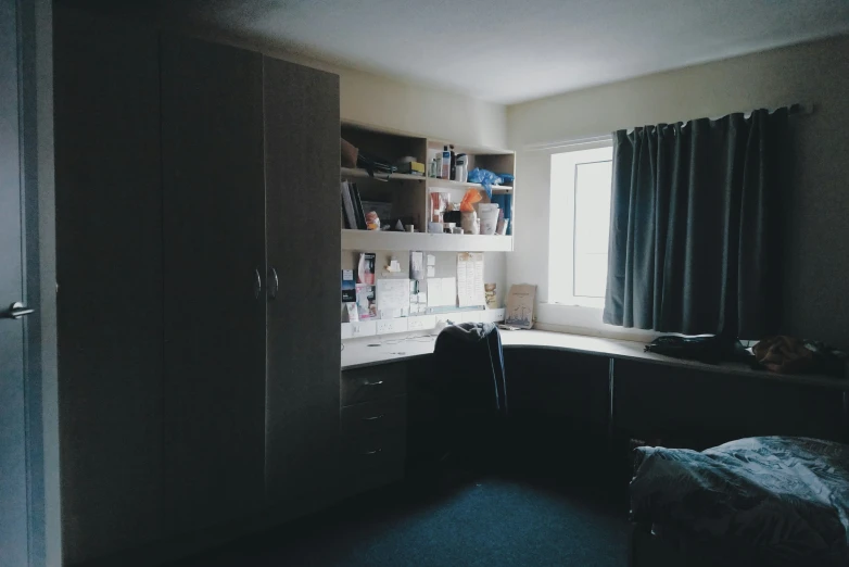 a room with a window, curtains, and cabinets