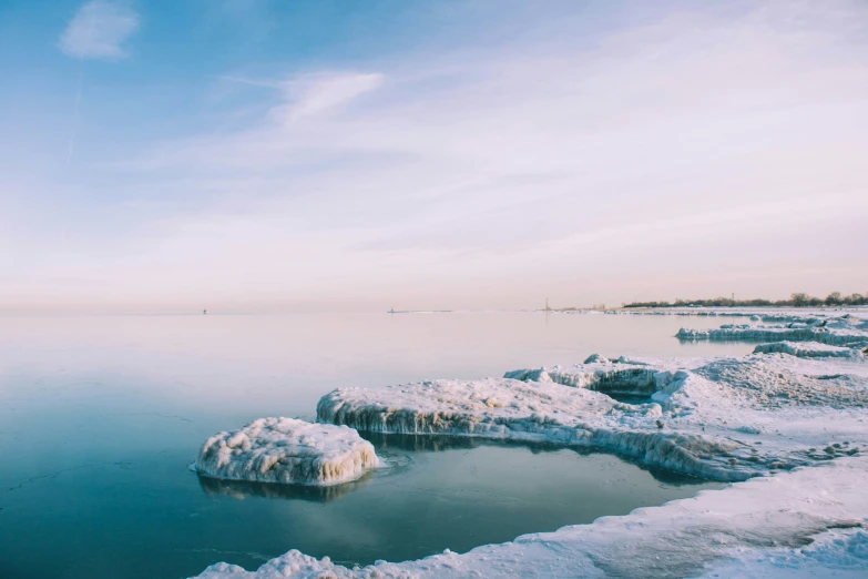 a bunch of ice chunks floating on top of a lake