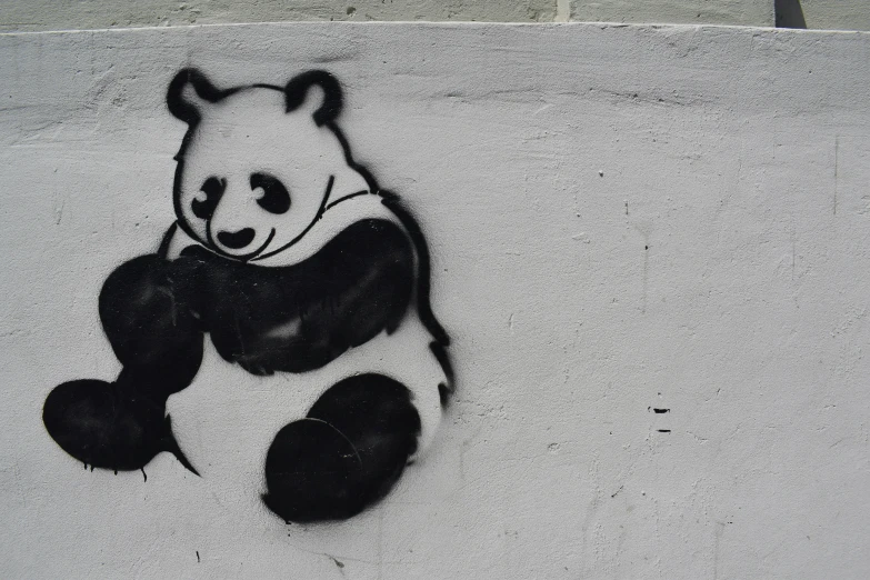graffiti of a panda bear on the side of a wall