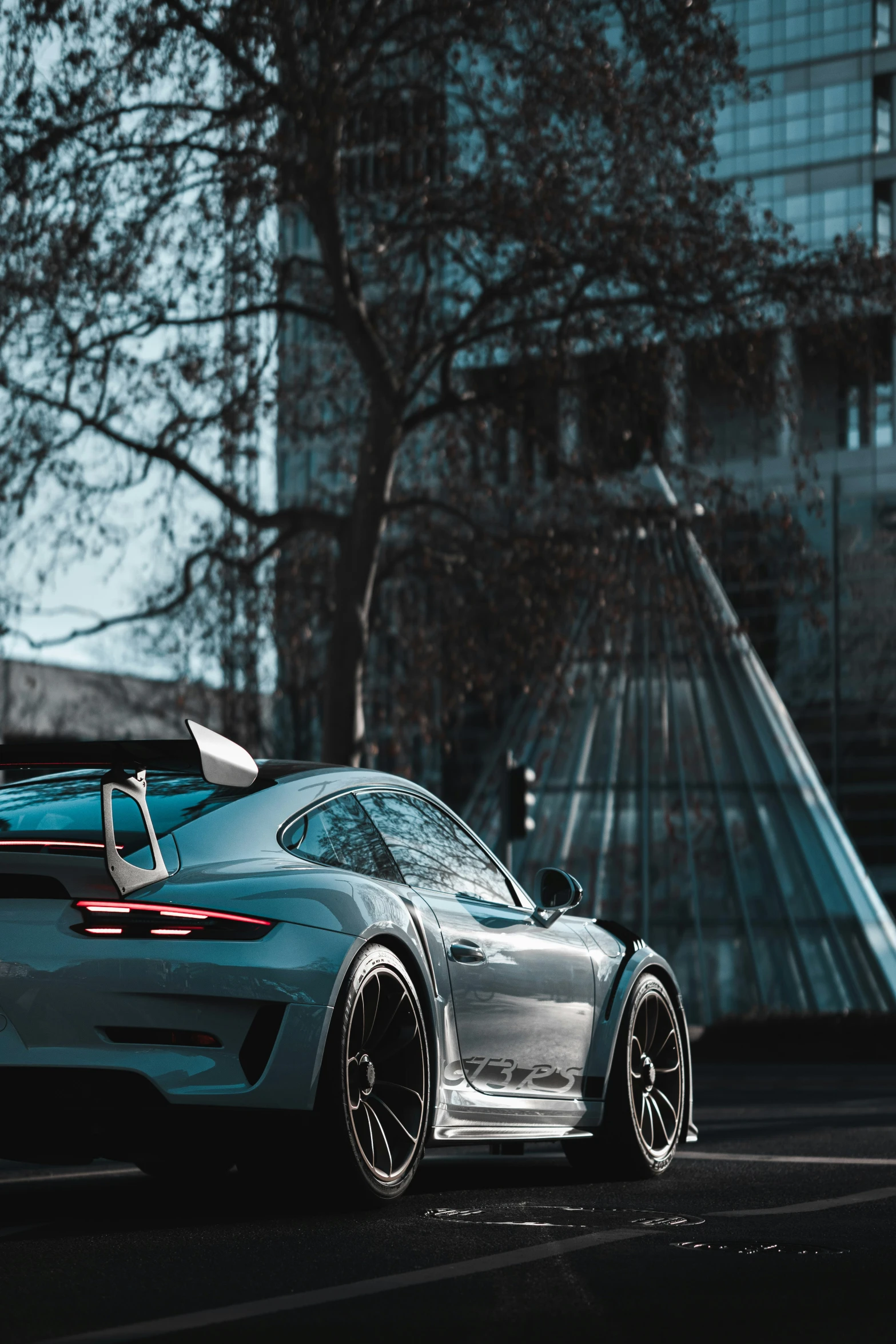 a shiny blue car is parked on the street