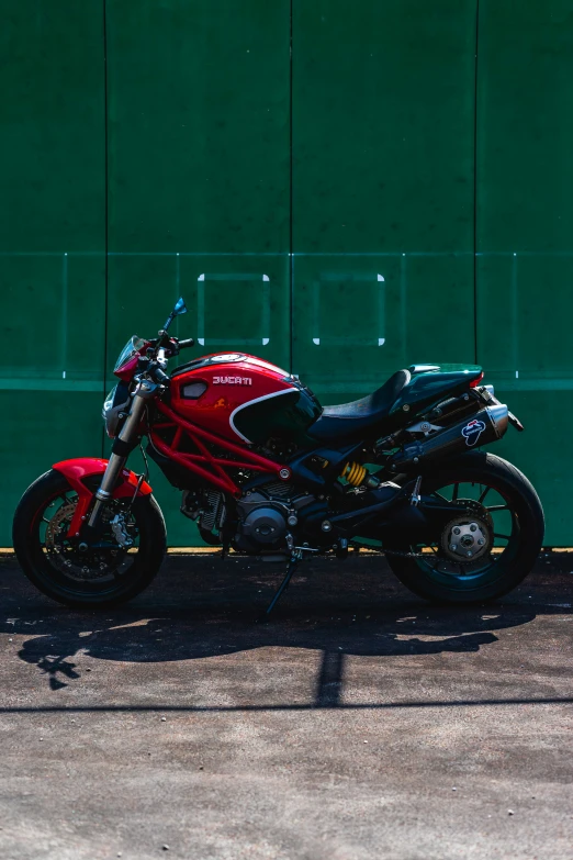 a motorcycle parked outside of a green building