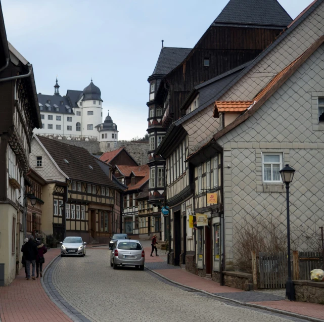 old buildings are beside a narrow cobbled road