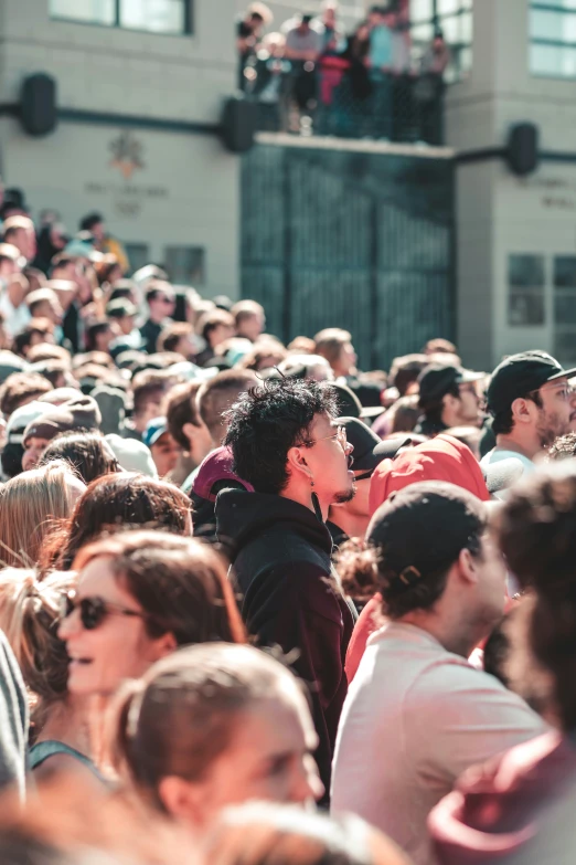 people standing outside during a festival with people on the roof