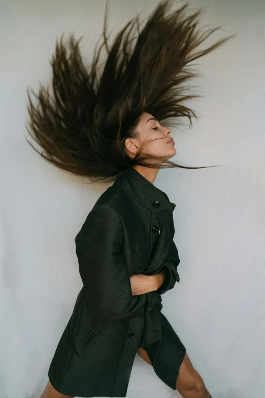 a woman with her hair in the air