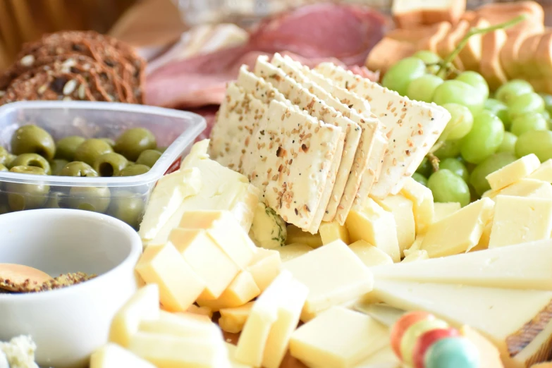 a variety of cheeses and gs arranged in rows