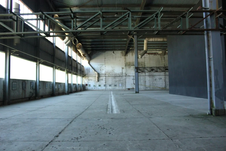 an empty building with pipes and other equipment