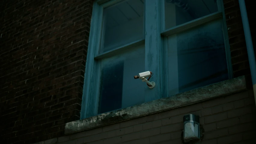 a security camera that is on the outside of a building